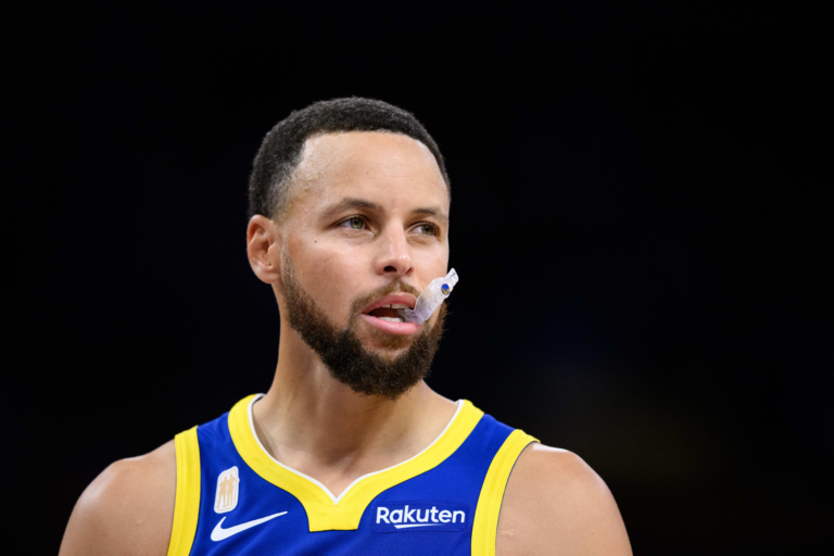 Golden State Warriors guard Stephen Curry wearing blue jersey with mouthguard during 2025‑26 NBA season